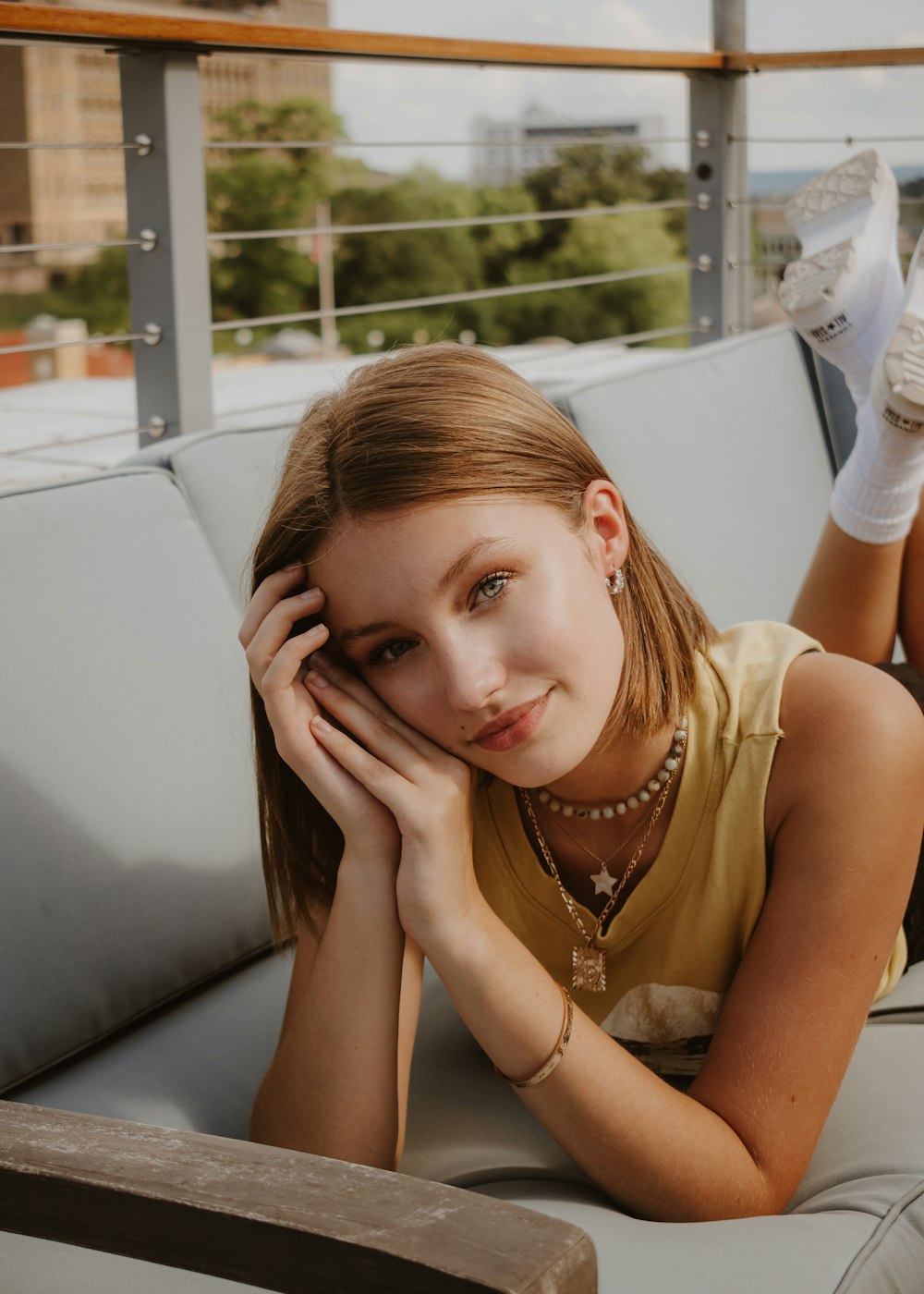 a woman laying on top of a white couch