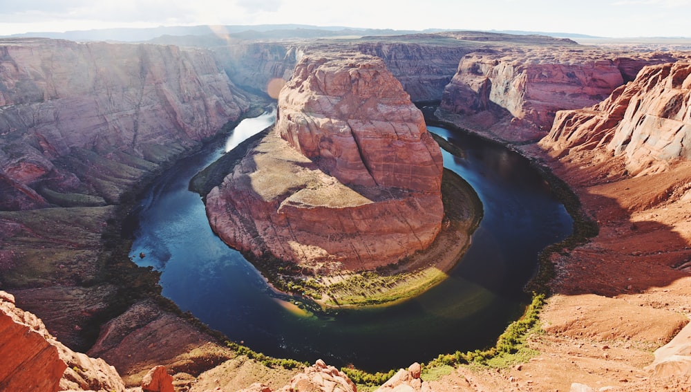 brown rock formation near body of water during daytime