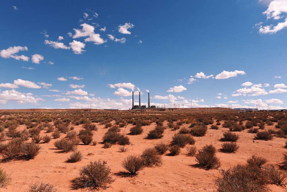 wind turbines on brown field under blue sky during daytime