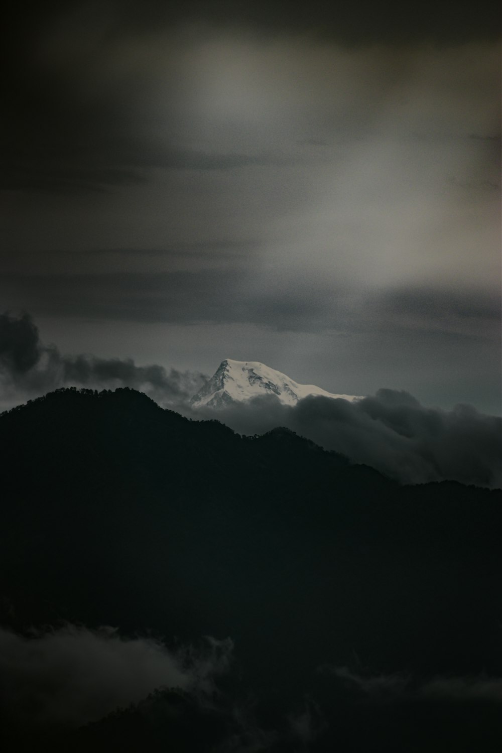 black and white mountains under white clouds