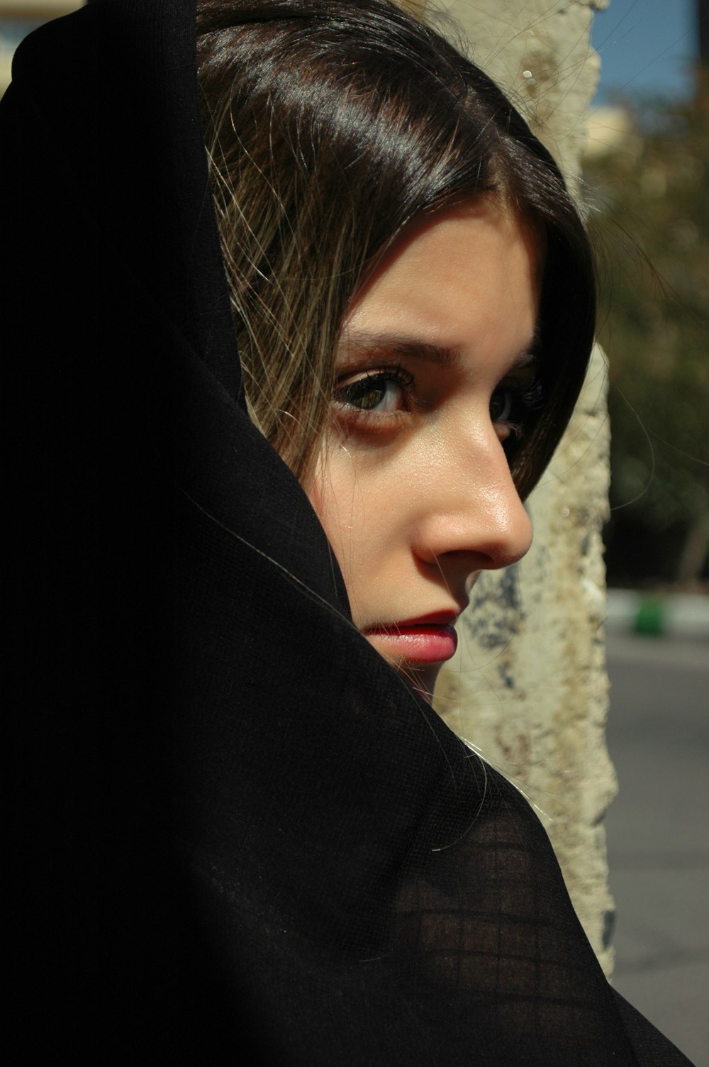 woman in black hijab and brown coat