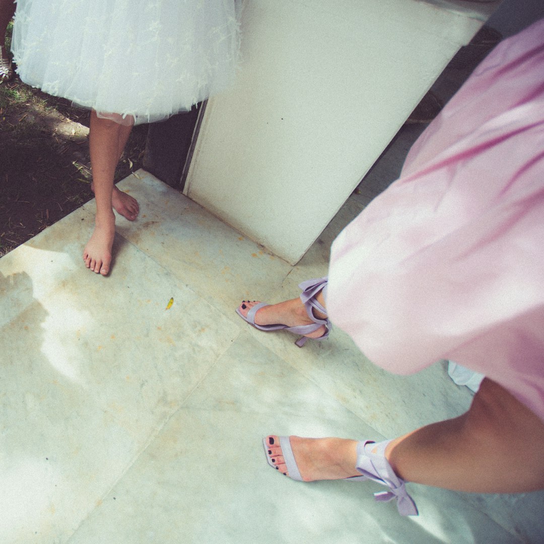 woman in pink skirt and blue and white sandals