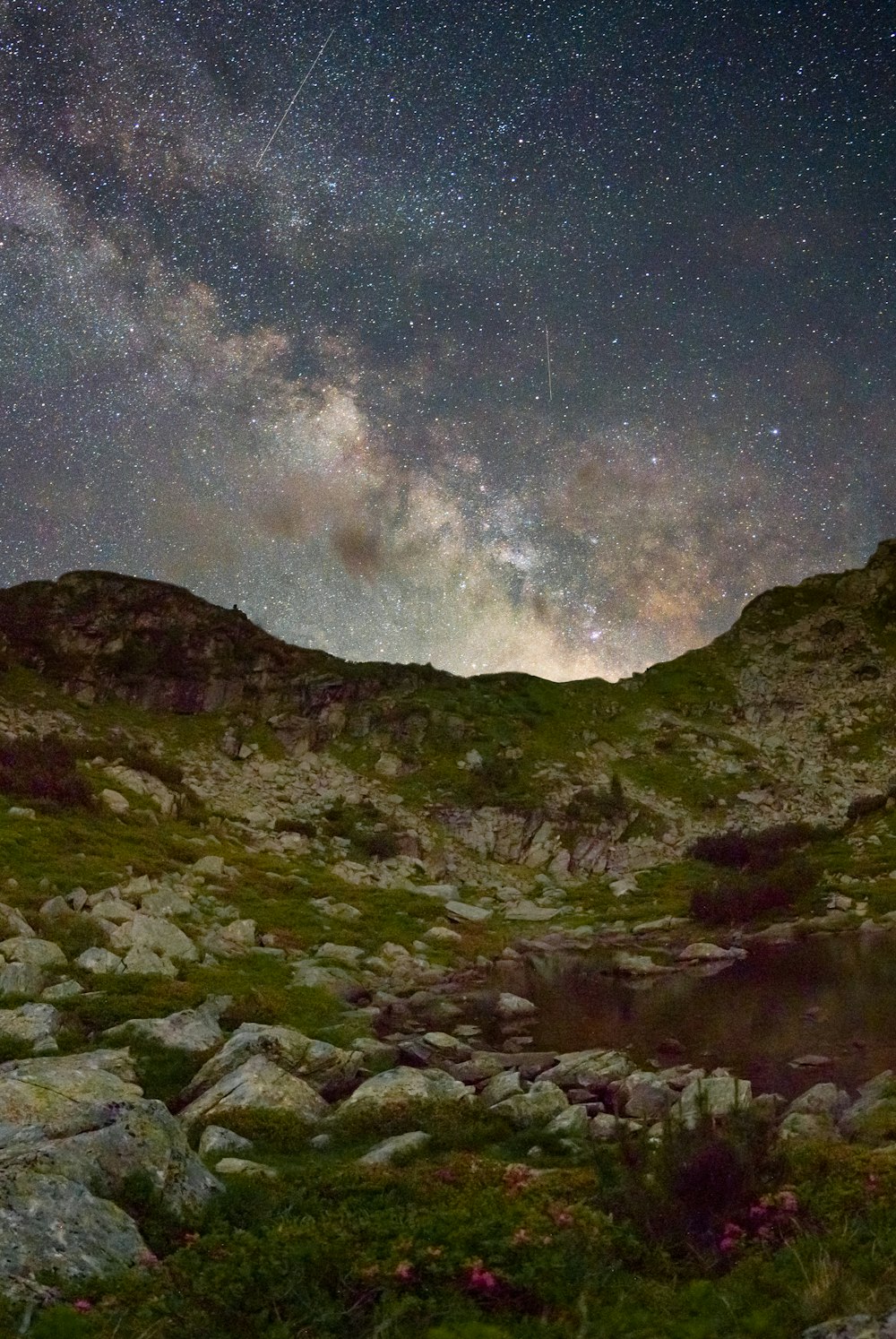 green and black mountain under starry night