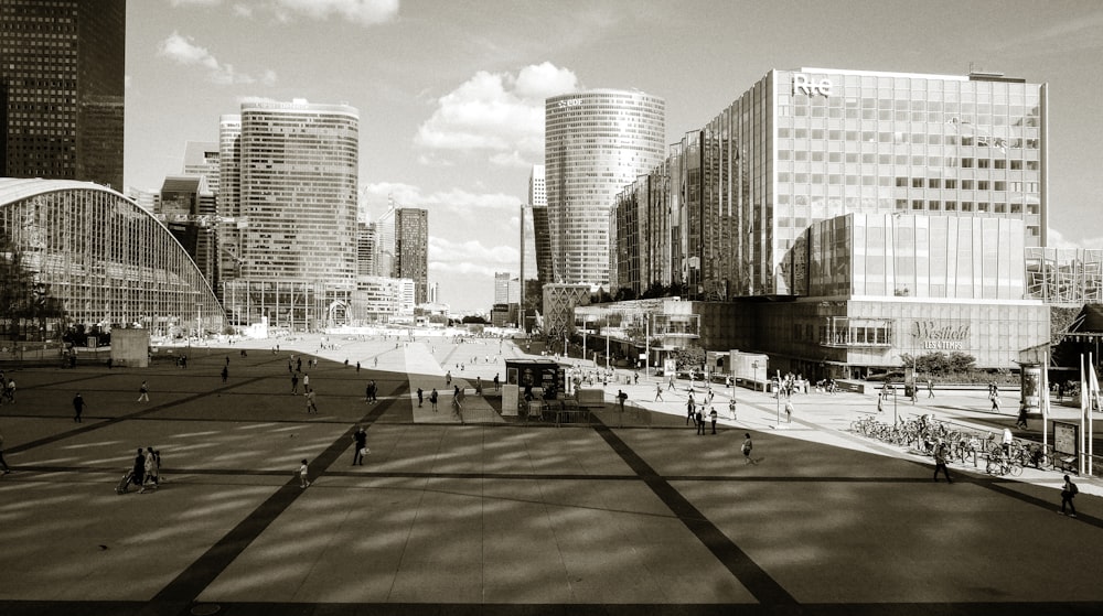 people walking on sidewalk near high rise buildings during daytime