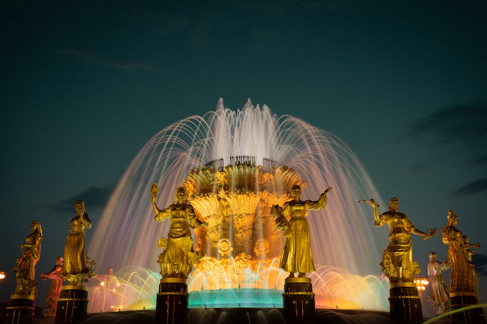 water fountain with lights turned on during night time