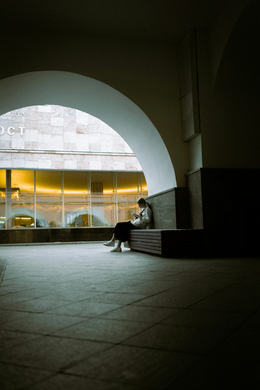 man in black jacket sitting on bench