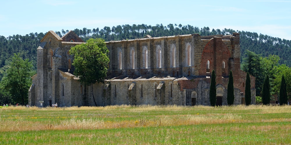 brown brick building near green trees during daytime