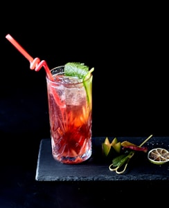 clear drinking glass with red liquid and ice