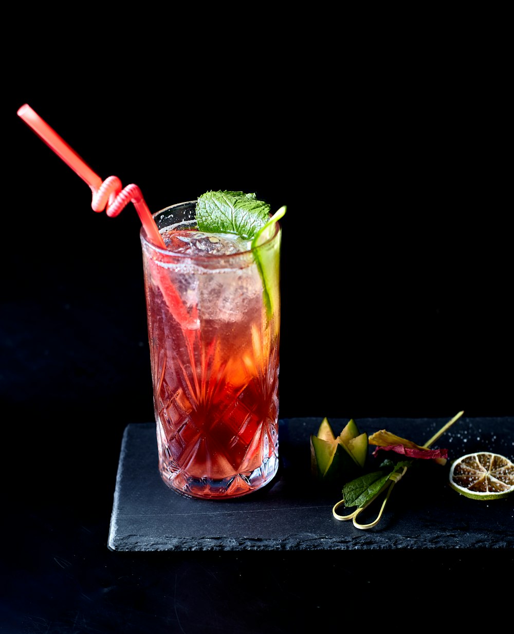 clear drinking glass with red liquid and ice