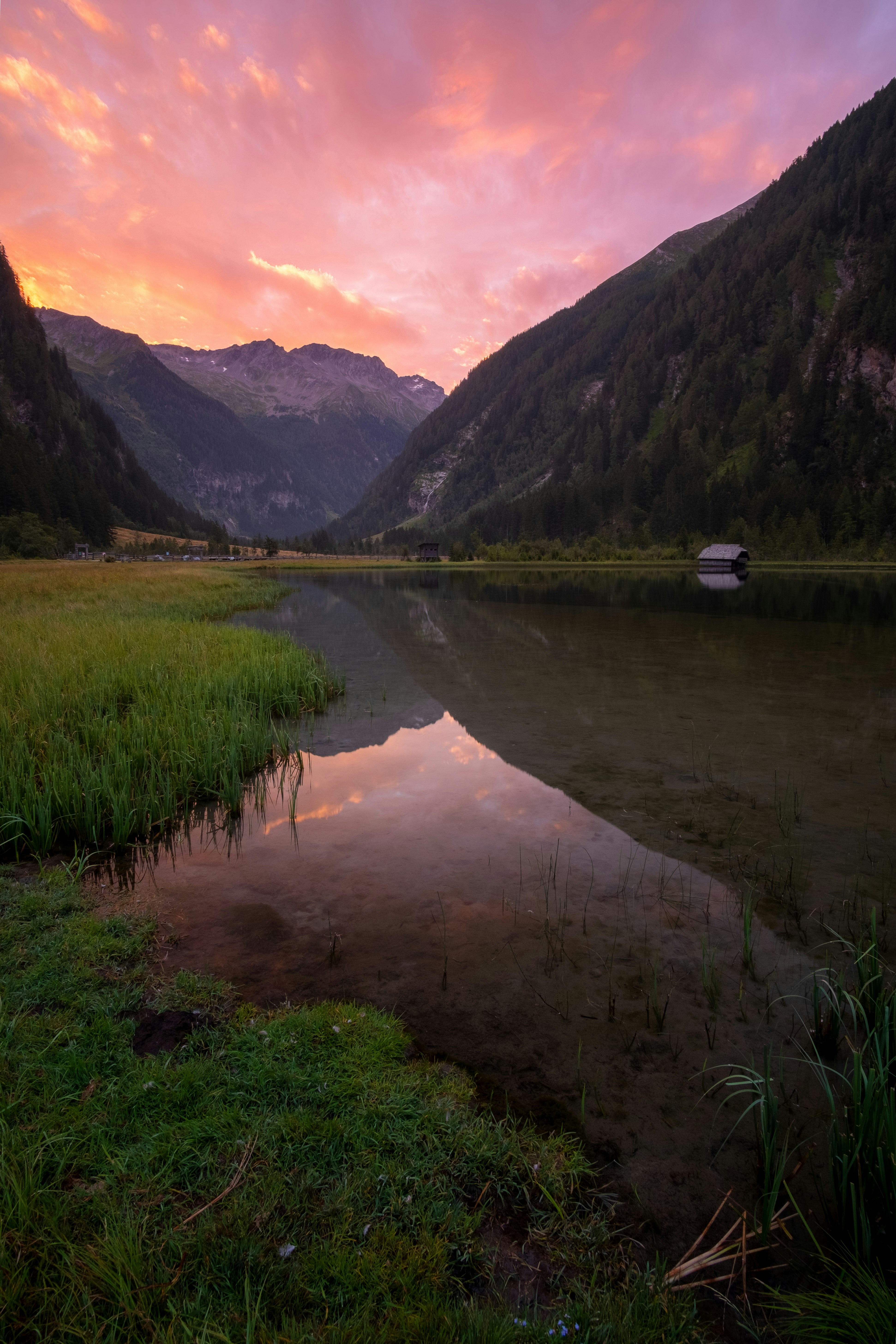 lake in the middle of mountains during daytime