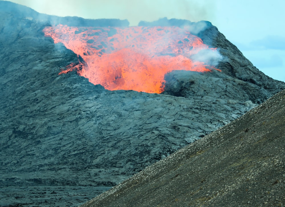 brown and gray mountain with orange smoke