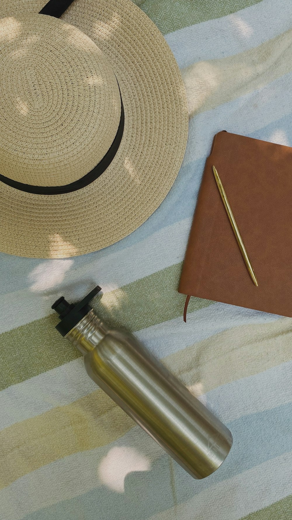 stainless steel bottle on brown table mat