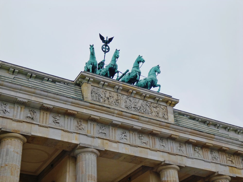 man riding horse statue under white sky during daytime