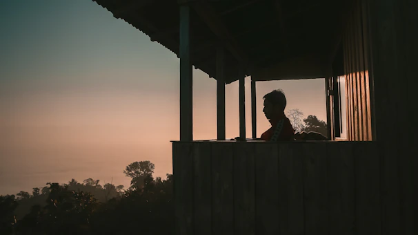 A peaceful morning scene of a resident journaling on the porch of a sober living home in Denver.