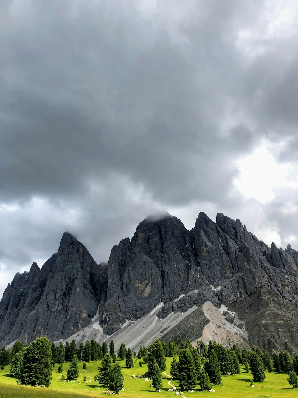 gray rocky mountain under white clouds during daytime