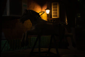 A neon-lit horse head silhouette glowing against a dark, code-filled background.