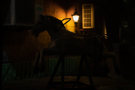 A neon-lit horse head silhouette glowing against a dark, code-filled background.