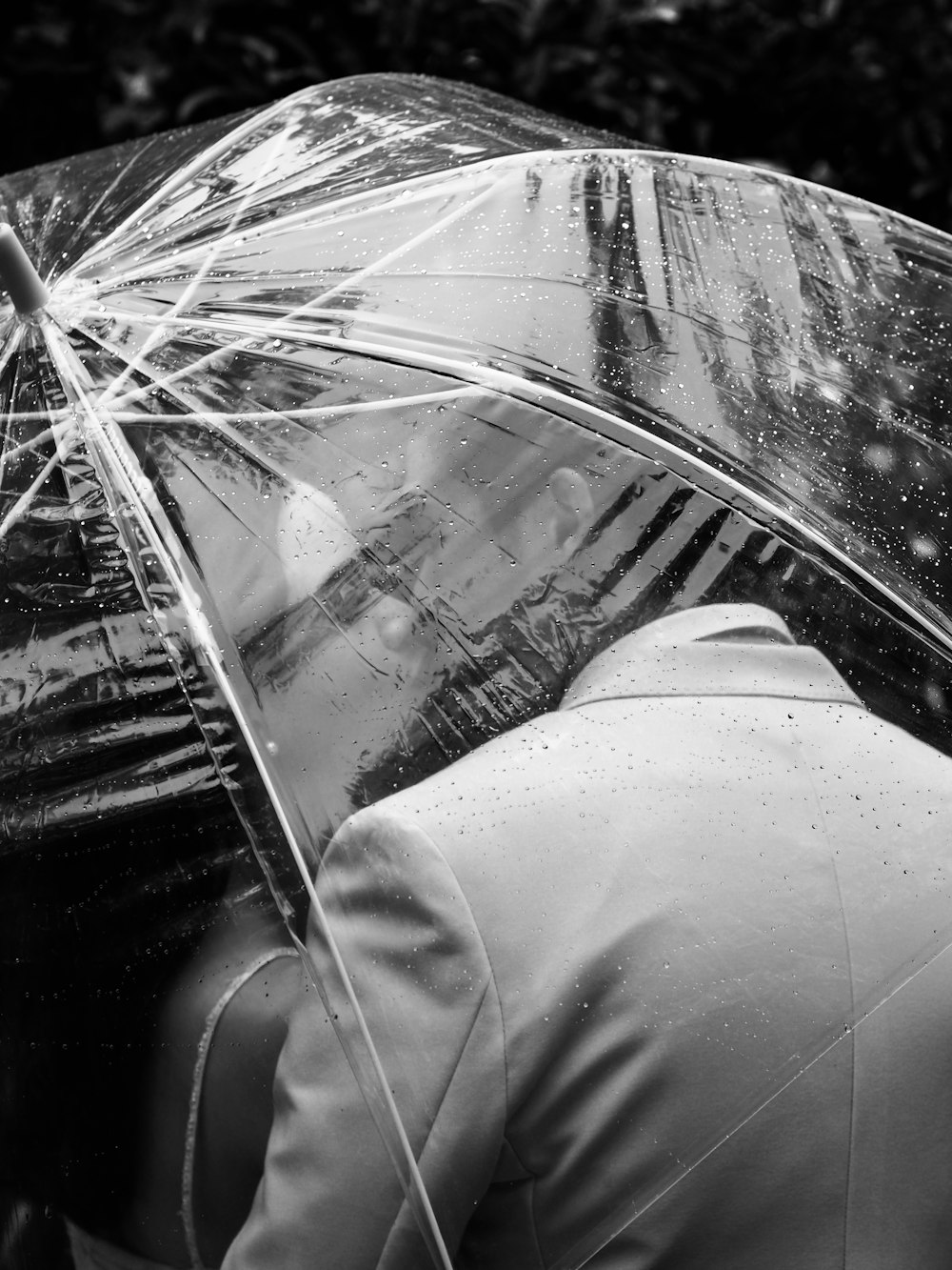 person in white pants under umbrella
