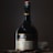 A bottle of St-Rémy Authentic French Brandy is set against a dark background. The bottle is elegantly designed with a black label featuring gold and red accents. The lighting highlights the curves and label details of the bottle, creating a sophisticated and classic appearance.