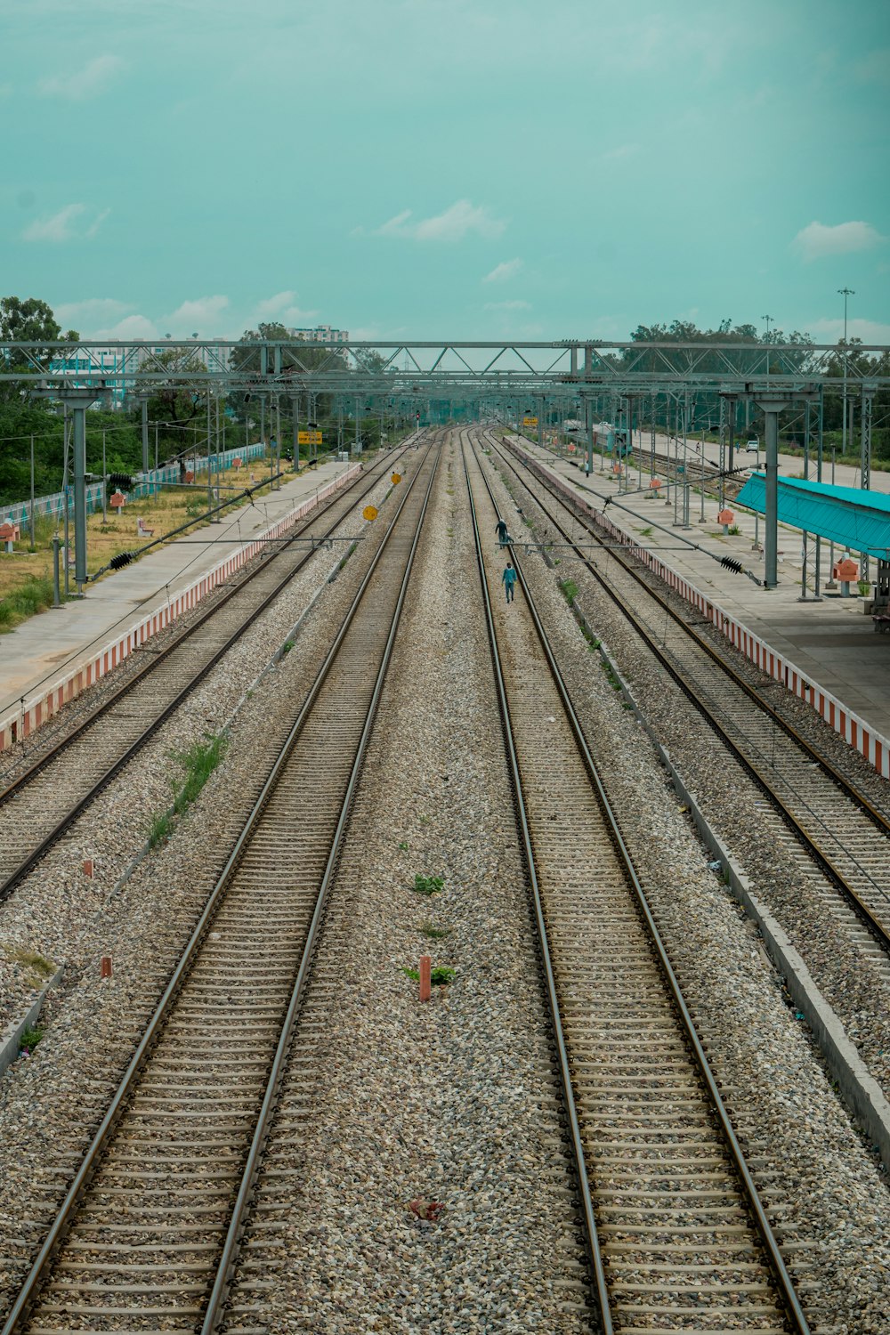 train rail under blue sky during daytime