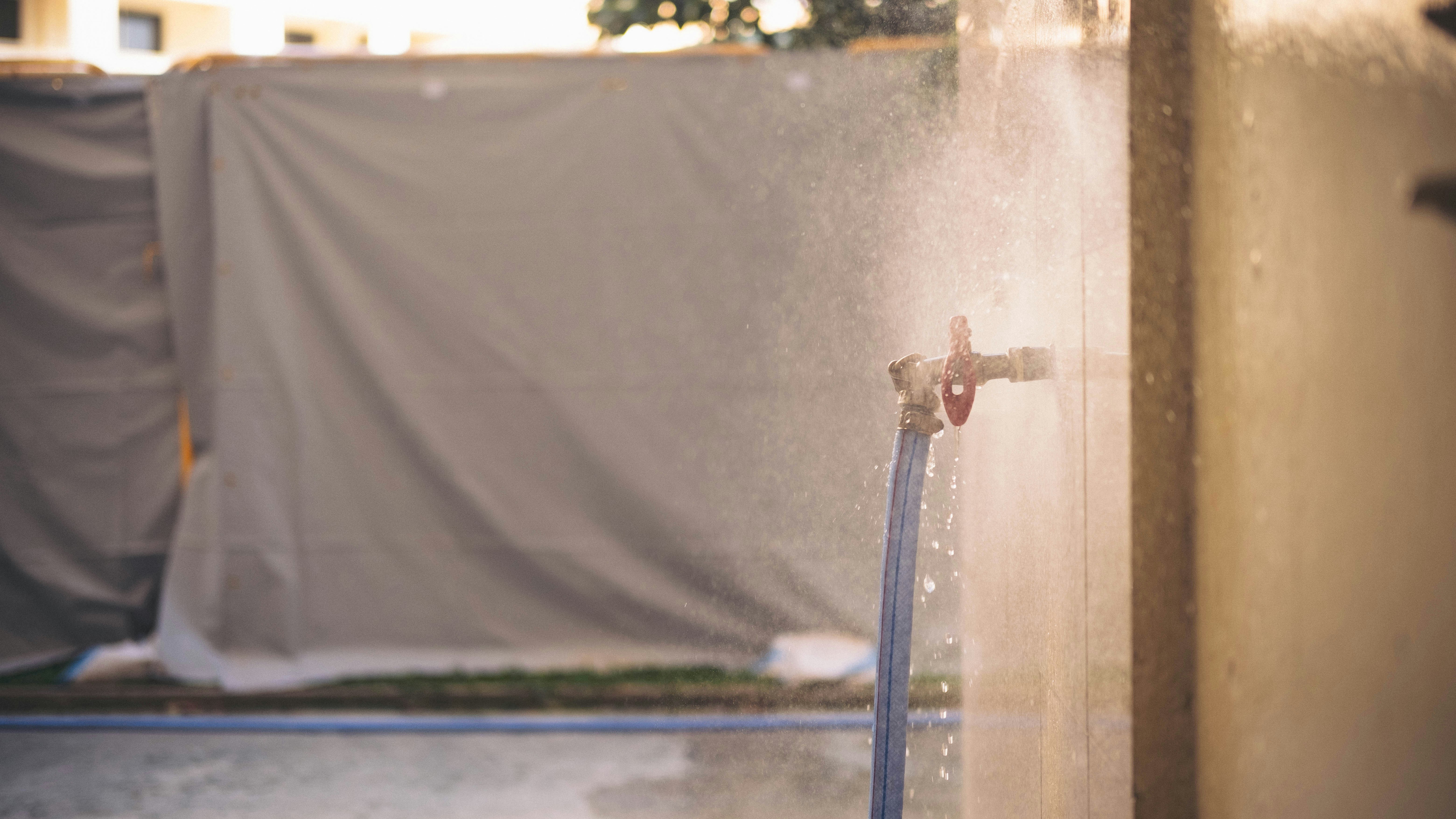 person in blue shirt and black pants standing on water fountain