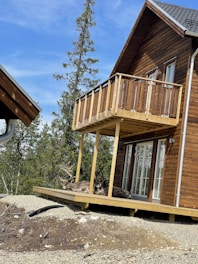 A cozy wooden house surrounded by Norwegian nature with soft natural light.