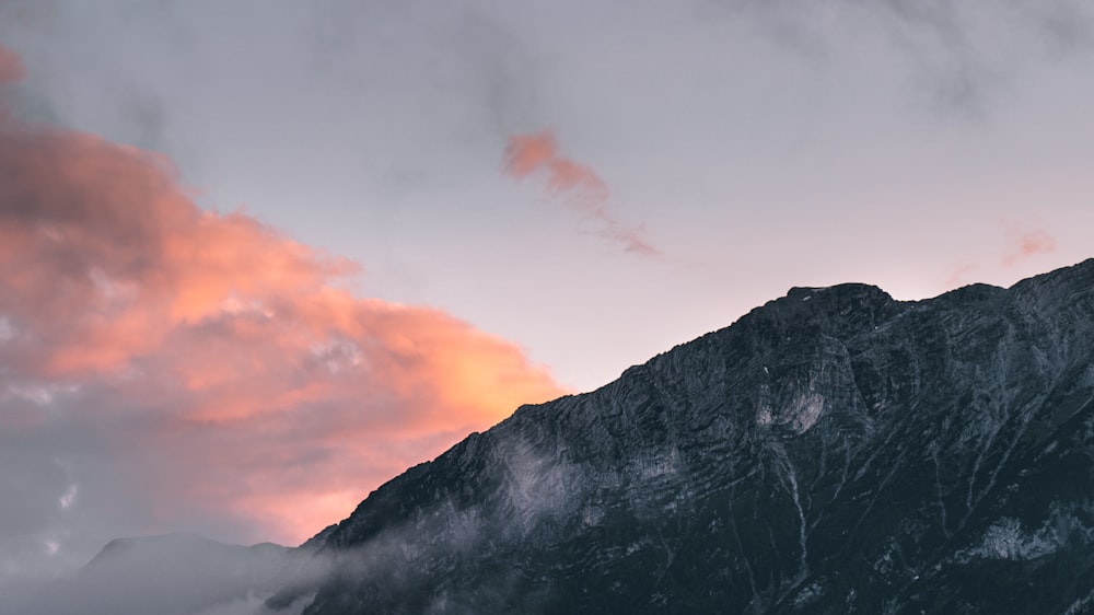 black and white mountain under cloudy sky during daytime