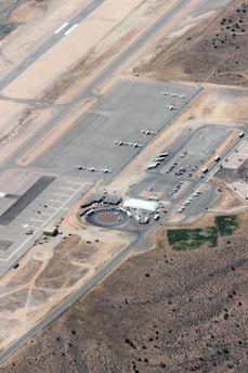 Aerial view of an airport with planes and ground services in action.