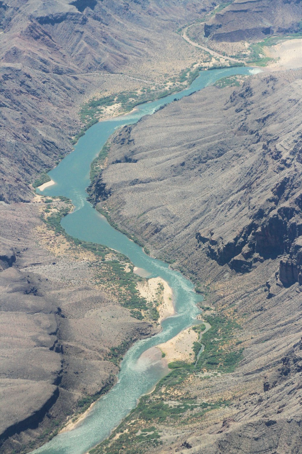 aerial view of lake between green mountains during daytime
