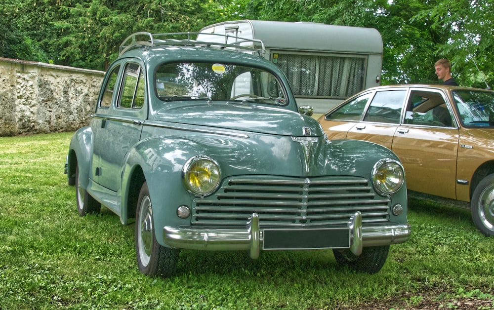 vintage black car on green grass field during daytime