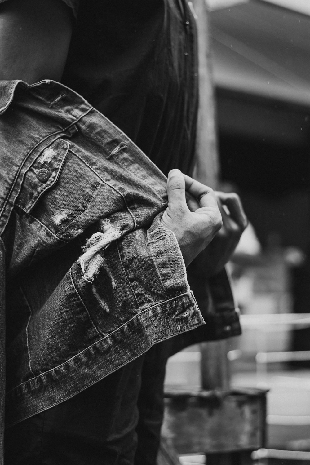 grayscale photo of person wearing denim jacket