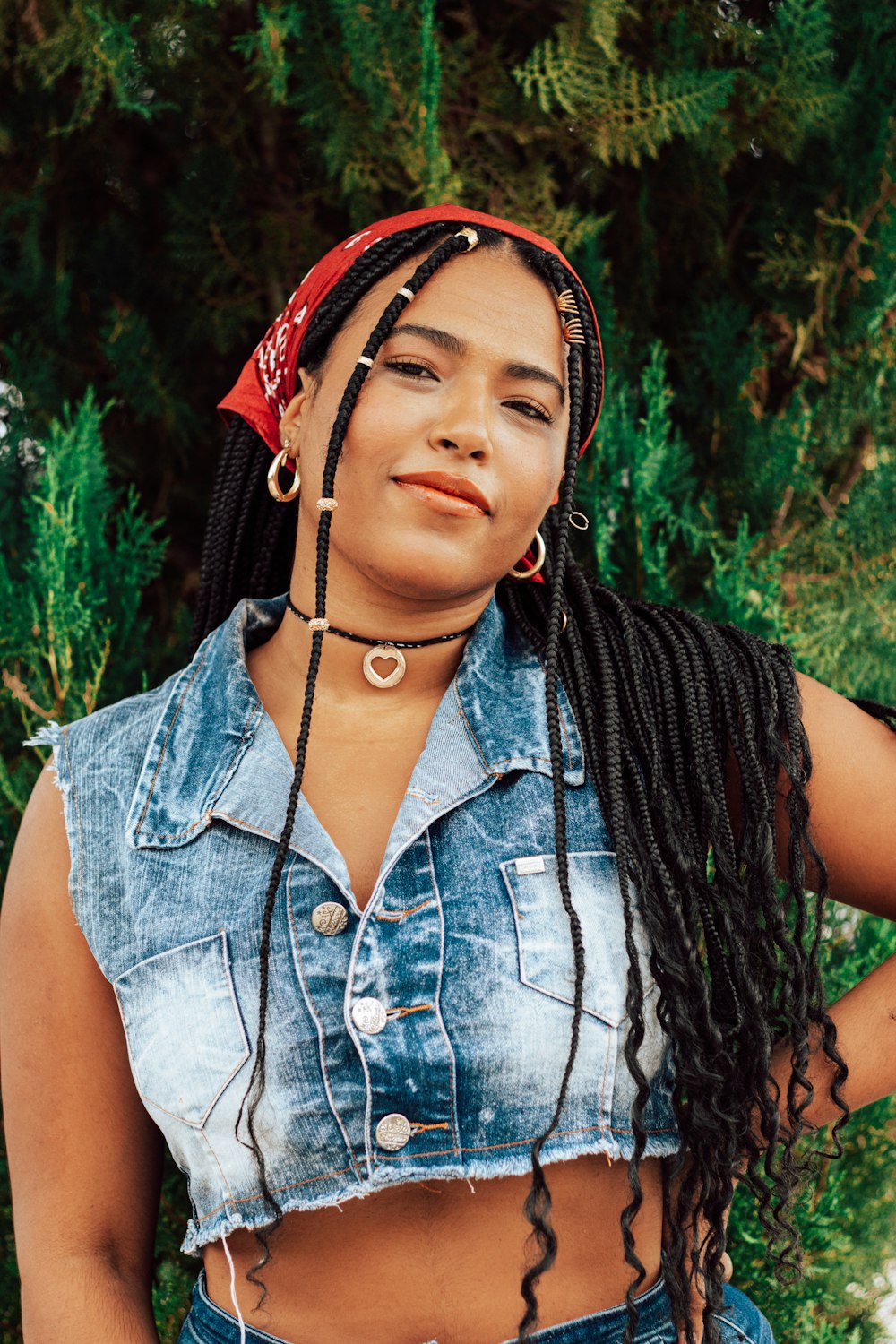 woman in blue denim button up vest and red and white floral headband