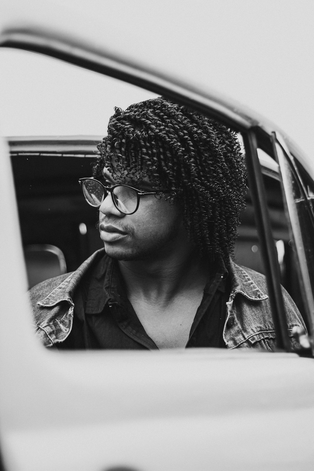 man in black sunglasses and gray jacket in grayscale photography