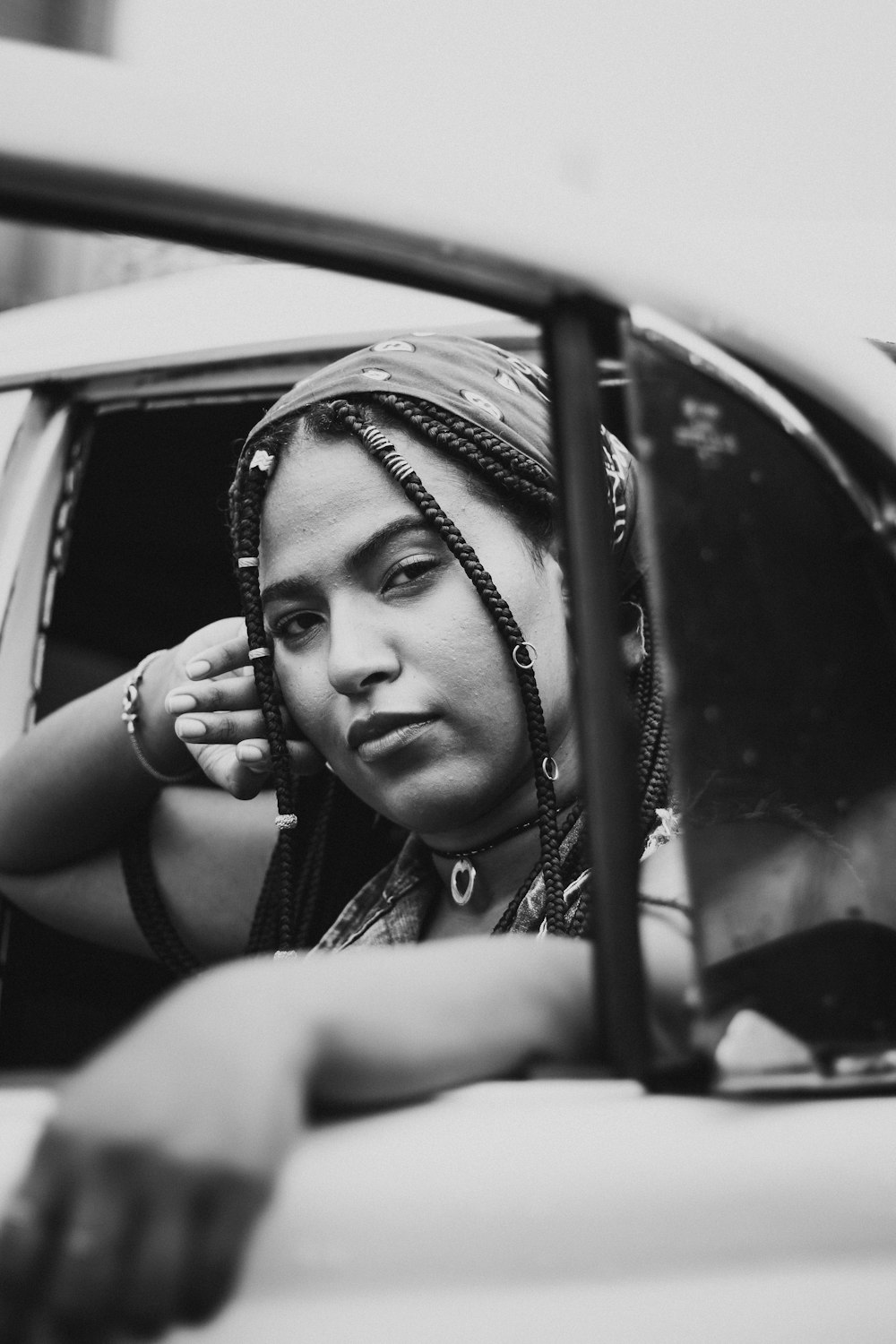 grayscale photo of woman in car