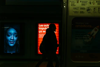 man in red jacket standing near window