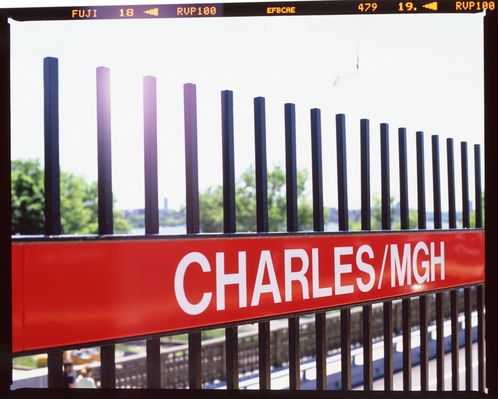 black wooden fence with red and white signage