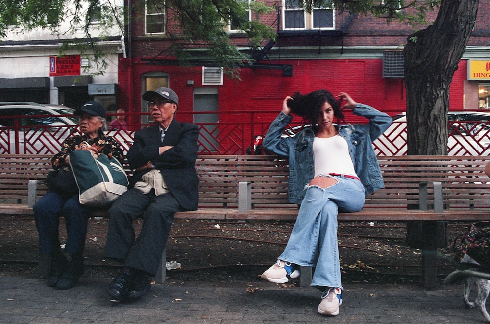 man and woman sitting on brown wooden bench