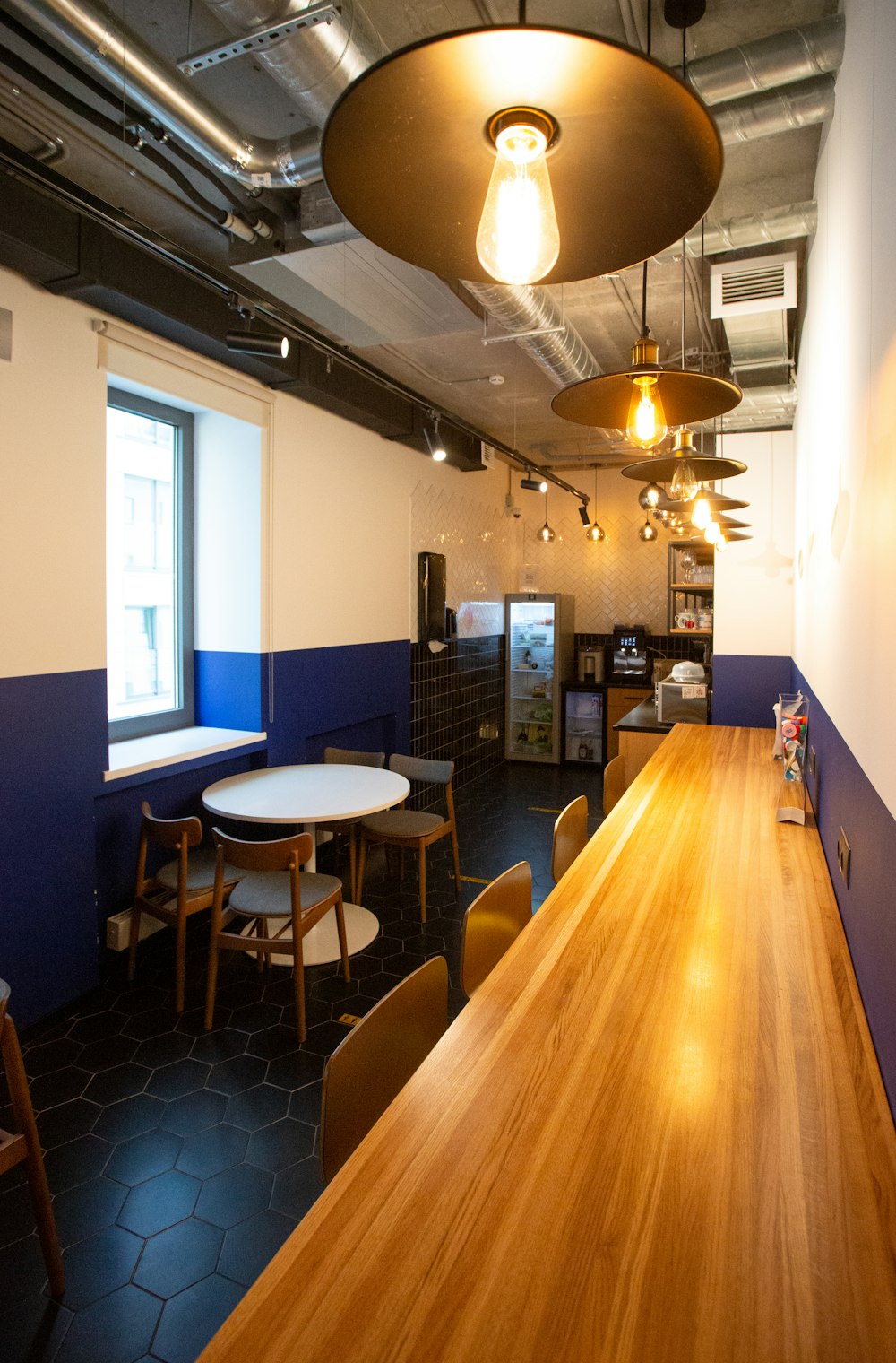 brown wooden table with blue padded chairs