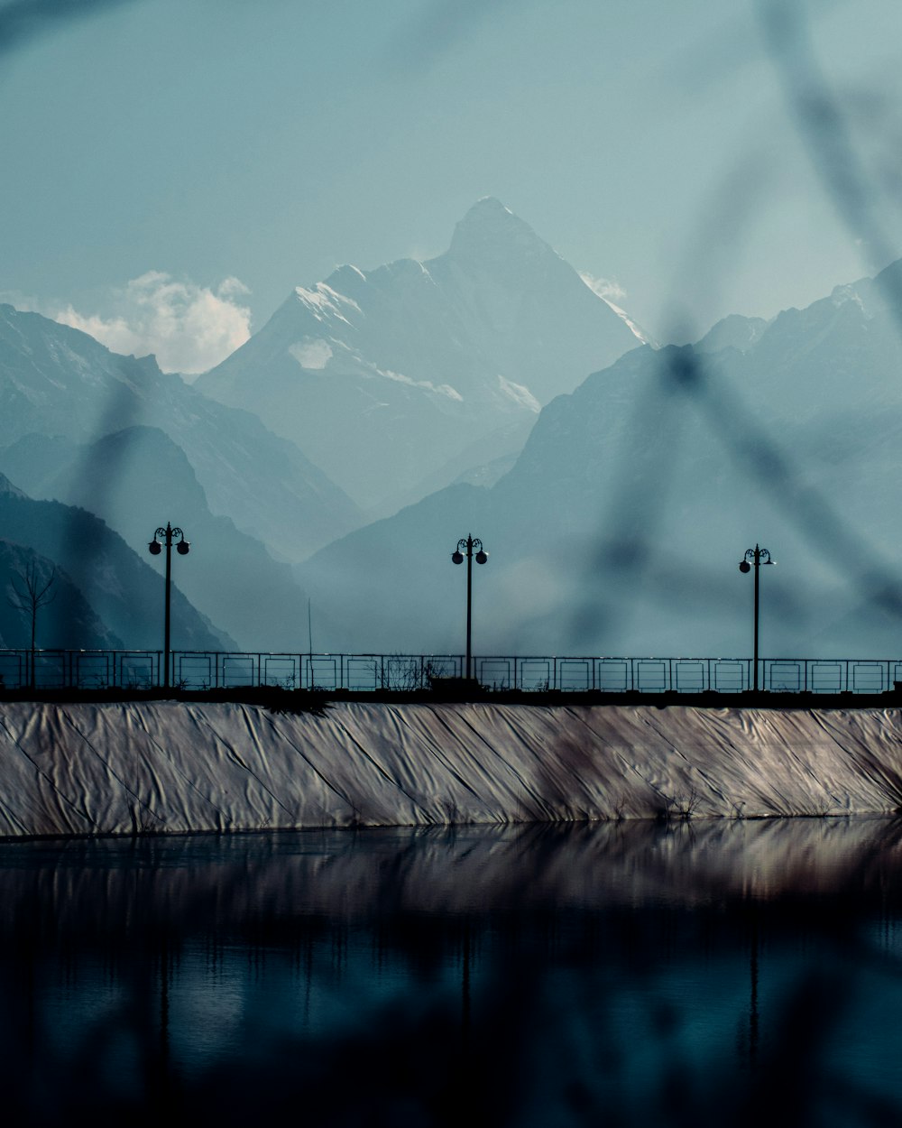 a large body of water with mountains in the background