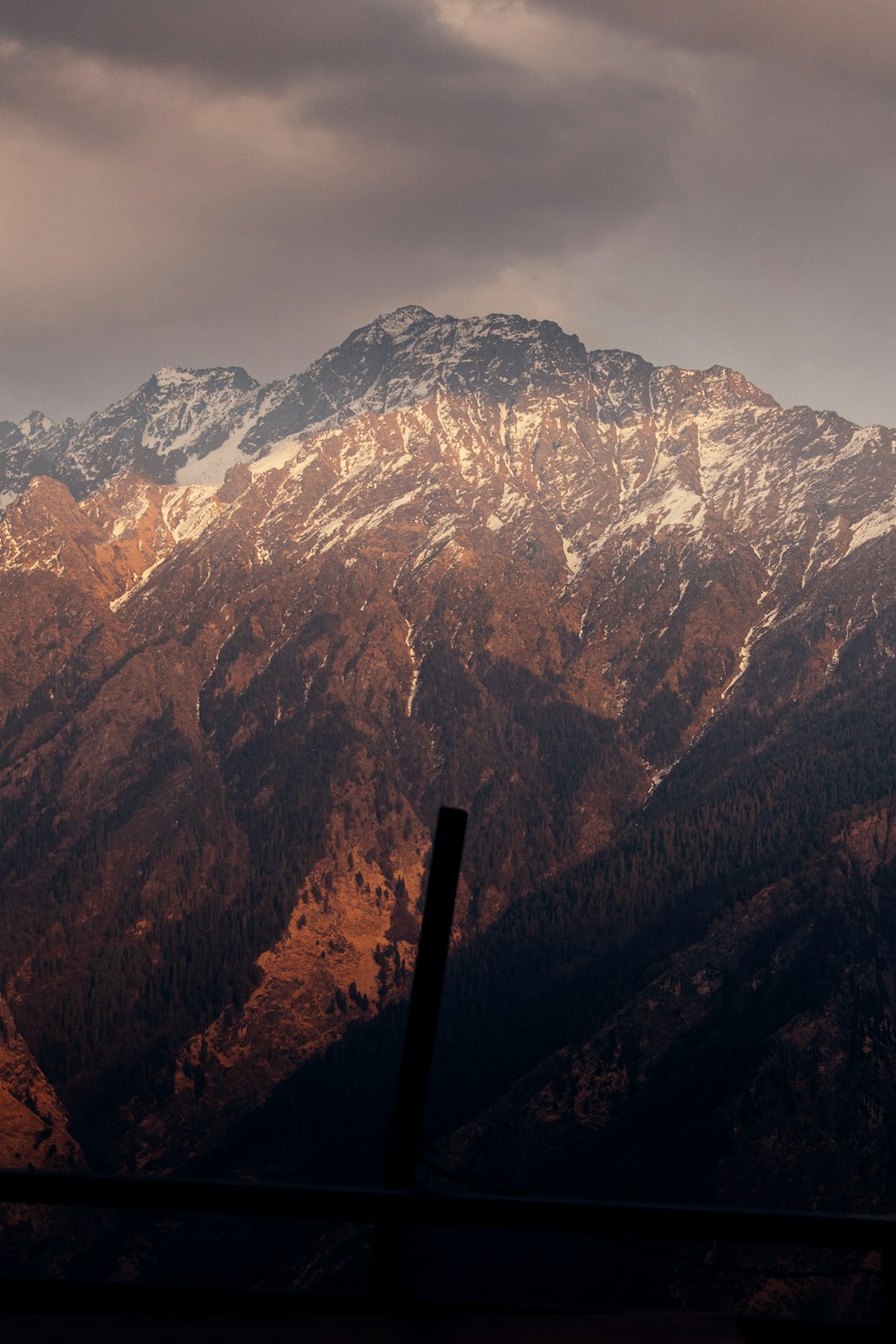 brown and white mountains under white sky during daytime