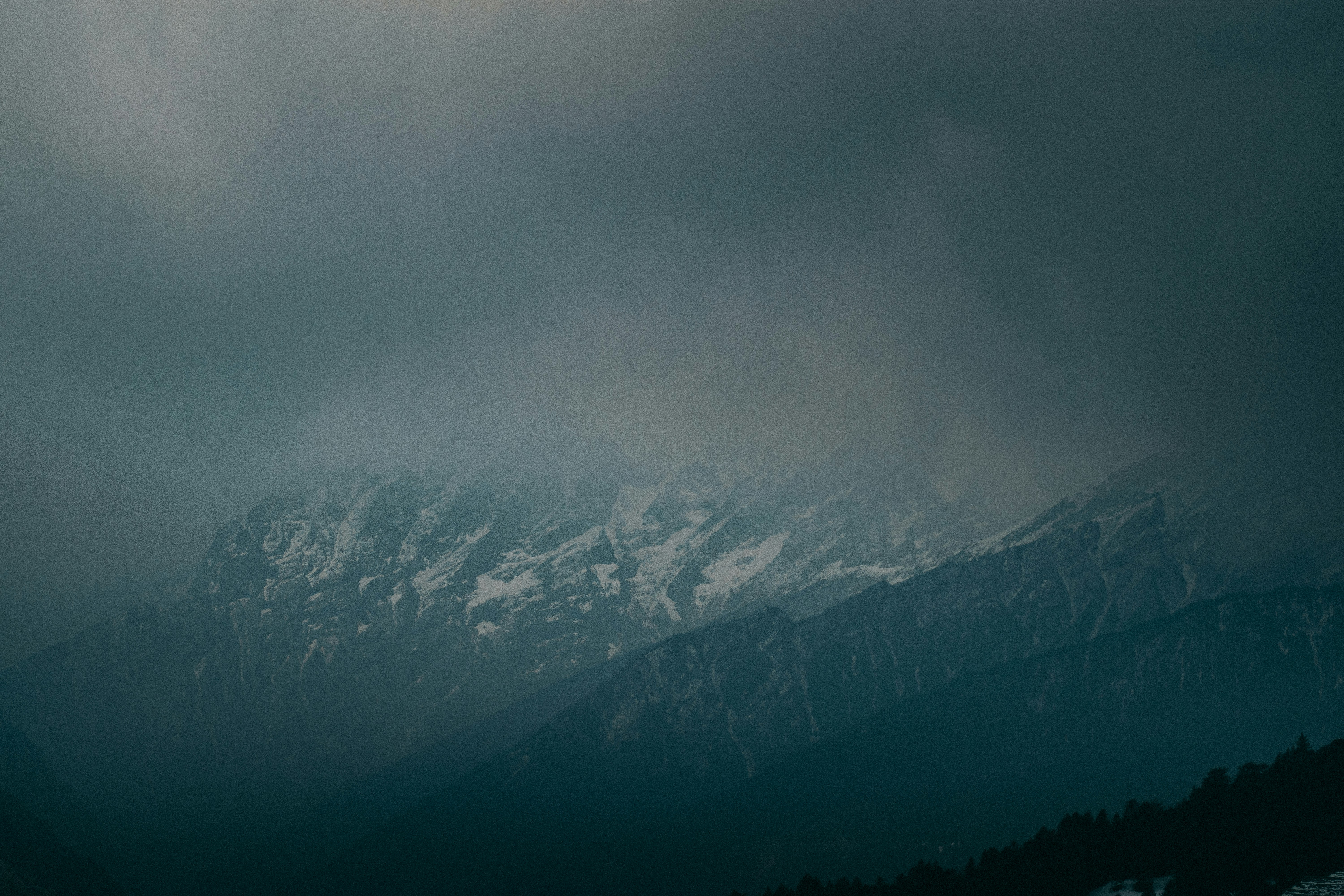 snow covered mountains under gray sky, dark weather in the Himalayas