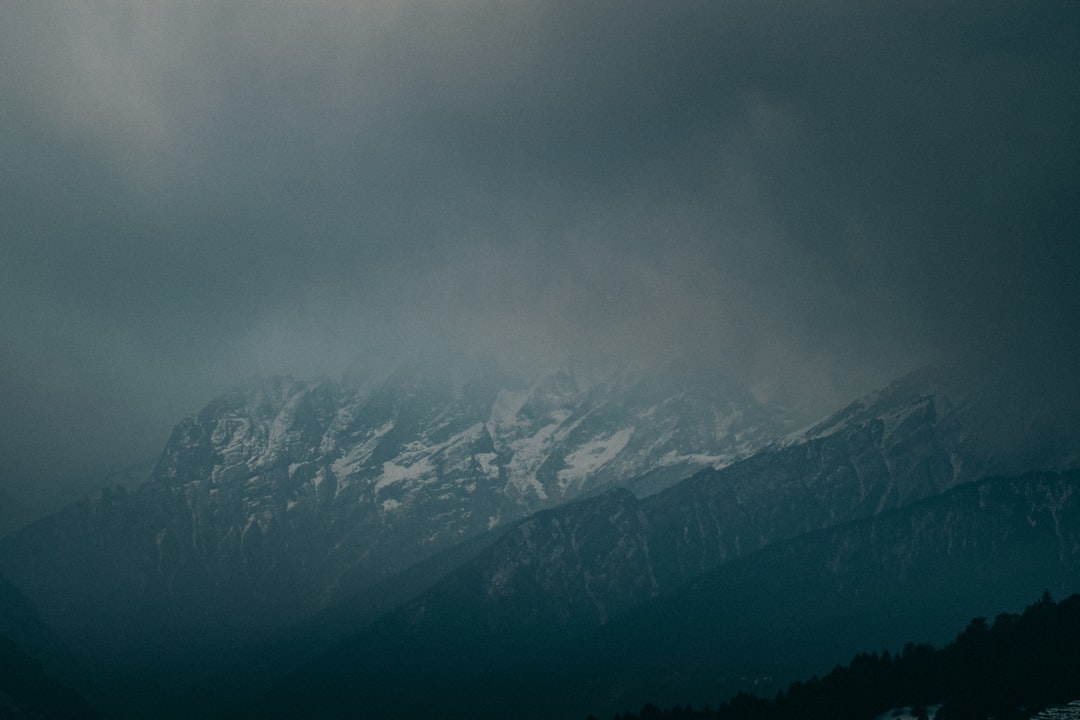 snow covered mountains under gray sky, dark weather in the Himalayas