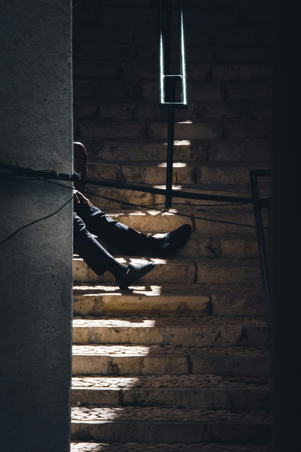 a person sitting on a set of stairs