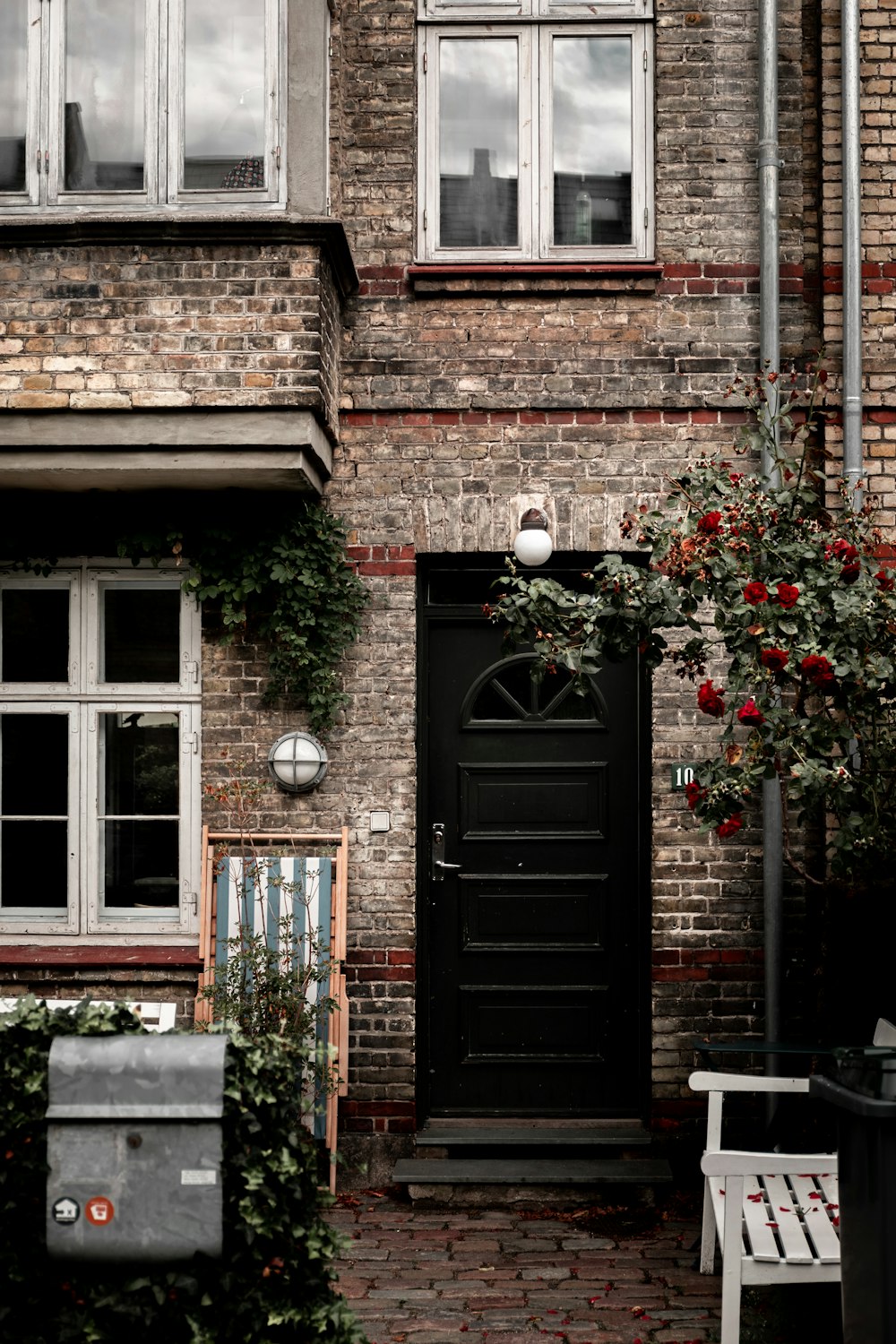 brown wooden door with red flowers