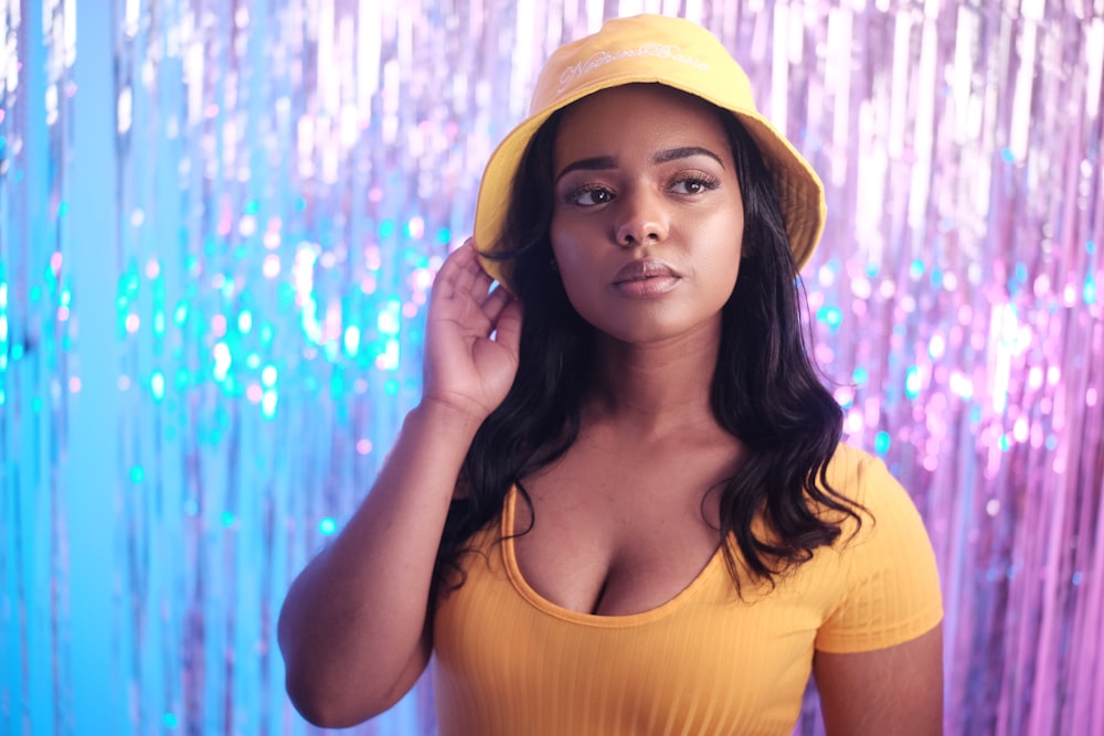 woman in yellow scoop neck shirt and yellow knit cap