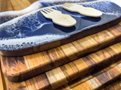 A stack of small cutting boards tied with a rustic twine bow, ready as a thoughtful gift.