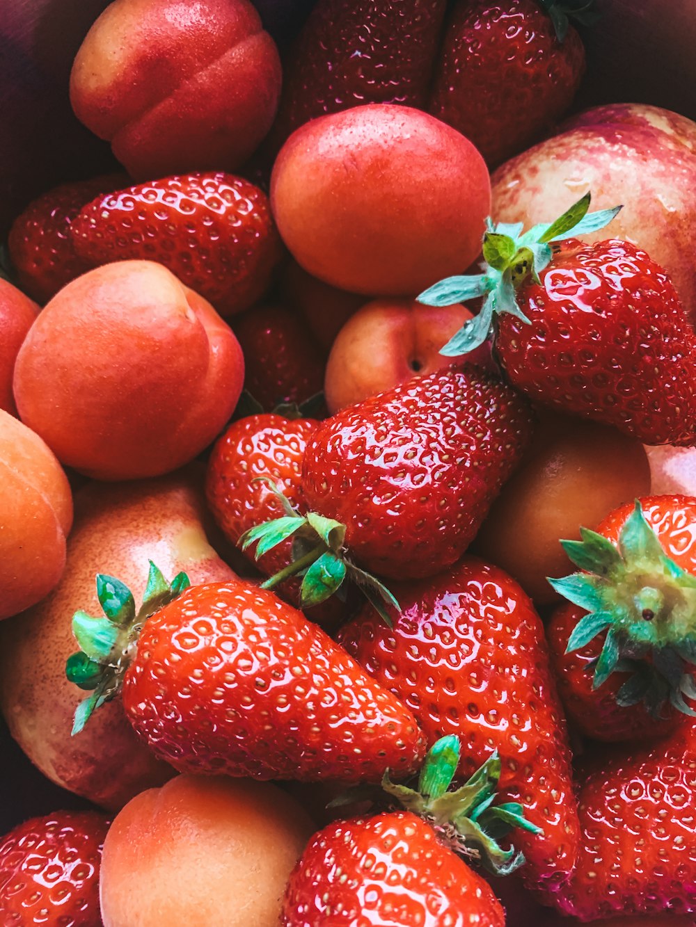 red strawberries on brown wooden table