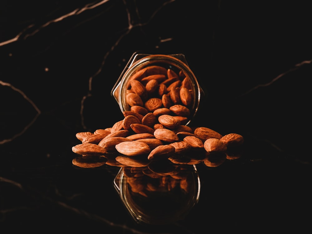 brown coffee beans in clear glass cup