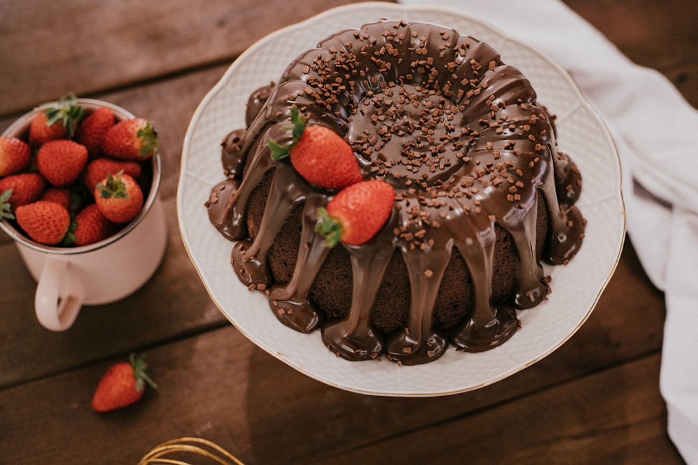 chocolate cake with strawberry on white ceramic plate