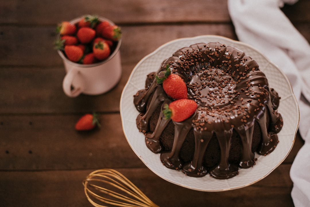 chocolate cake with strawberry on white ceramic plate